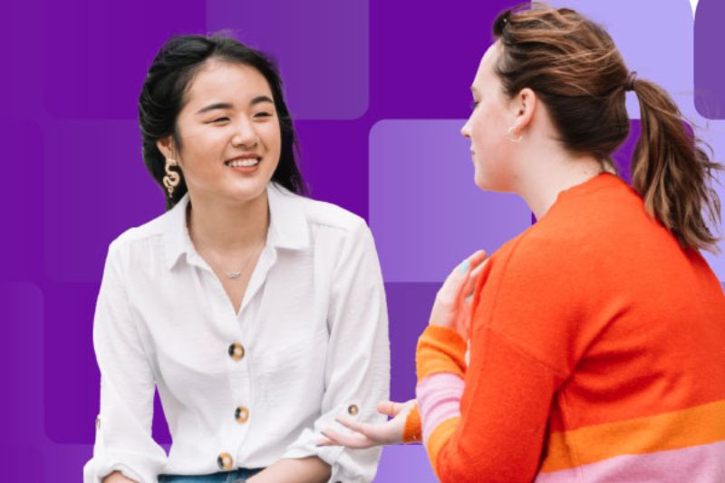 two female students sitting chatting